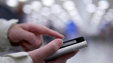 Woman using her mobile phone on beautiful blurred lighting background inside Walmart store
