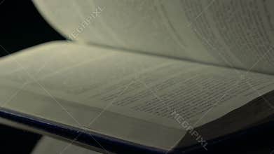 Fast flipping book pages.