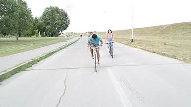 Group of friends having fun cycling and taking selfies with phone