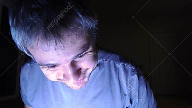 Man opening illuminated drawer in dark room, close up. Success, find, discover and surprise concepts. 4K video