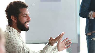 African-american man discussing with colleagues during a meeting