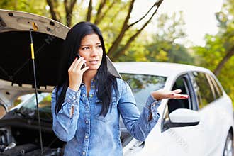 Woman with a broken car calling for assistance