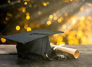 graduation cap, hat with degree paper on wood table, abstract li