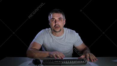 Guy afraid of watching online movie. Emotions of fear. Studio