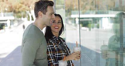 Young couple window shopping in town