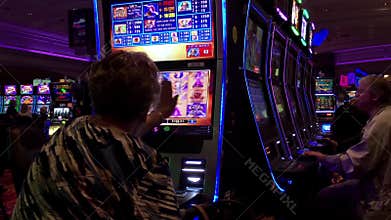 Motion of people playing slot machine