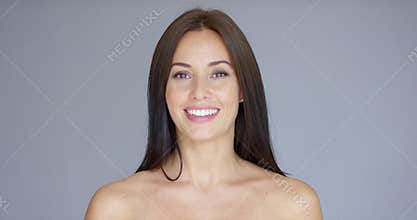 Single smiling woman over gray background