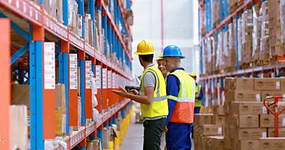 Male and female warehouse worker inspecting stock