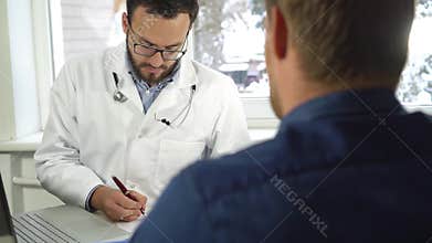 Medical consultation - doctor and patient sitting by the table