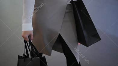 Female hands holding a shopping bags close up in mall center