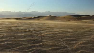 Wind blowing on sand dunes
