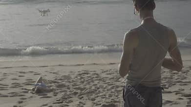 Beautiful model posing for male photographer at the beach