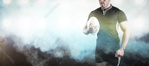 Composite image of tough rugby player holding ball