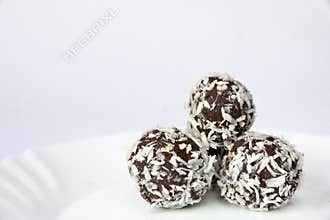 Christmas sweets on a plate - Rum balls in coconut. Traditional homemade handmade Czech sweets.