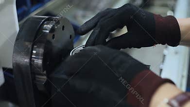 Worker installing rubber gaskets into industrial unit. Manufacturing process