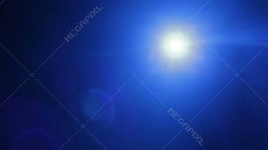 A beam of blue light from a profile spotlight directed onto the stage in total darkness