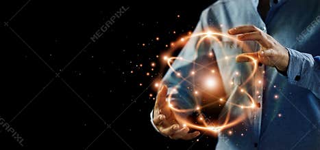 Abstract science, hands holding atomic particle, nuclear energy