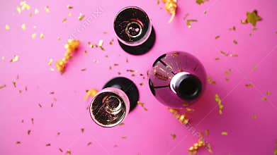 Bottle and two glasses full of sparkling champagne wine with golden decoration