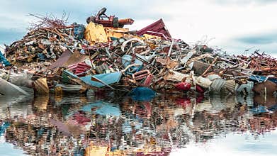 Environmental Pollution of the sea. A pile of junk, metal gabage and plastic in the ocean.