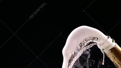 Opening champagne bottle closeup. Sparkling Wine over Black Background. Slow motion