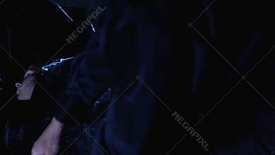 Forensics expert putting evidence number and looking at dead girl in body bag