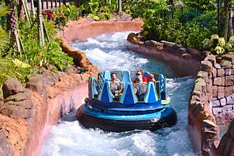People on board the raft, crossing river rapids at Seaworld Theme Park.
