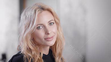 Happy young blonde business woman portrait indoor