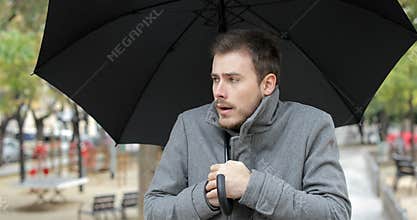 Man getting cold walking in winter under the rain