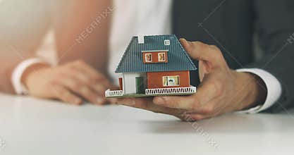 Real estate business - salesman showing new family house model