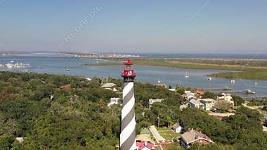 Aerial footage in 4k of flying around Saint Augustine lighthouse with the beach and Lions bridge on the background