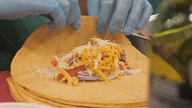 Chef hands wrap vegetable filling in bread cake in kitchen restaurant close up