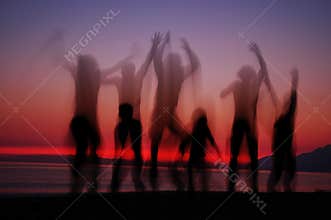 Jumping people in sunset