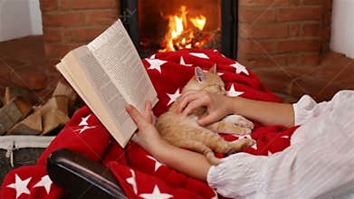 Holidays season relaxation. Reading a book and watching the fire