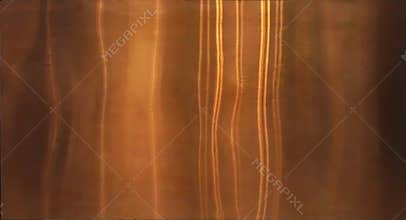Shiny gold foil, bronze, or copper metal pattern surface texture. Close-up of interior material for design decoration background