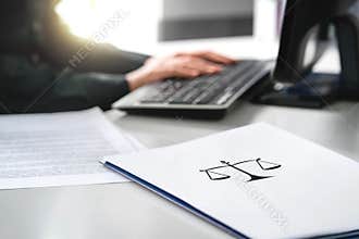 Attorney with computer. Lawyer working in law firm and company.