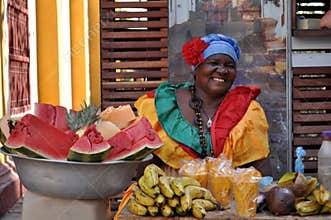 CARTAGENA, COLOMBIA - JULY 30: Palenquera woman sells fruit on July 30, 2016 in Cartagena, Colombia. Palenqueras are a unique