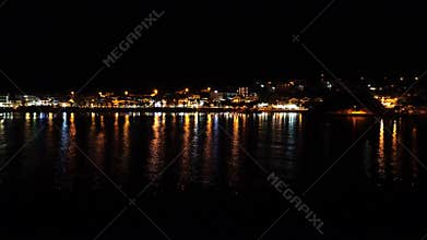 Sea with beach by night wide