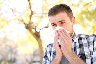 Ill or allergic man coughing in a park