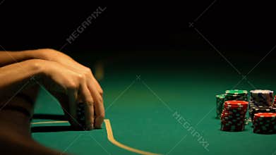 Woman thinking over strategy in poker and betting all-in, bluffing, closeup