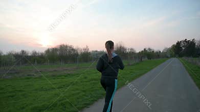 Pretty young woman jogging outdoors