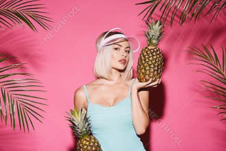 Pretty girl at pink studio background