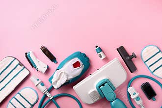 Kit of modern professional steam cleaners on pink background. Top view, flat lay. Banner with copy space. Cleaning service concept