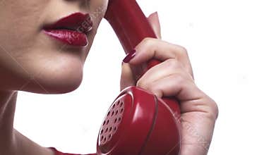 Young girl with red lipstick and nails is talking on the phone and saying I love you