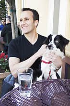 Man and dog at a street cafe