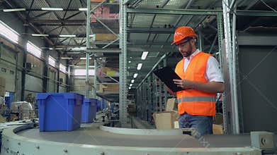 Portrait male near conveyor with parcels