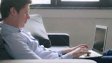 Guy entering data or computer at home