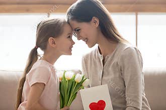 Cute little kid daughter congratulating happy mom with mothers day