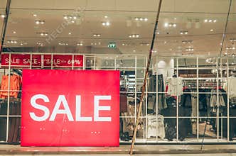 Sales promotion of women fashion clothes retail store in shopping mall, sale label sign sticker in front of shop door glasses