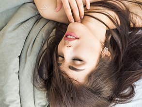 Girl with beautiful hair lying on the bed. Skin care concept
