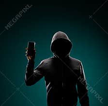Computer hacker in hoodie. Obscured dark face. Data thief, internet fraud, darknet and cyber security concept.